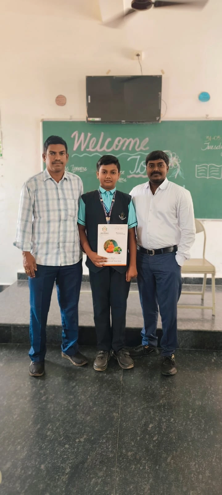 Student certificate presentation with teachers