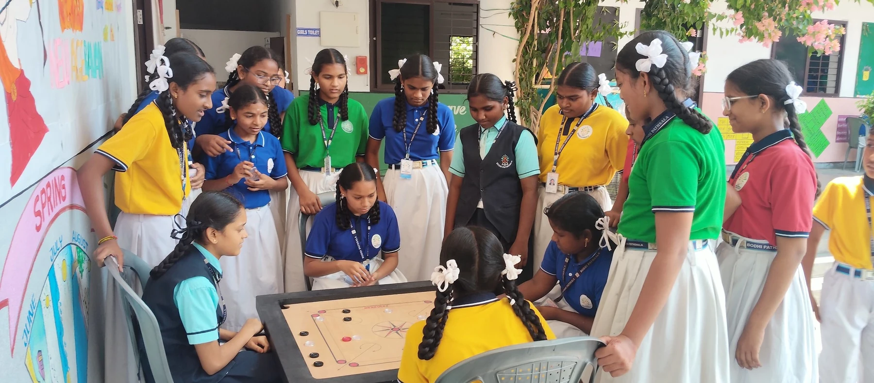 Students enjoying a team carrom activity