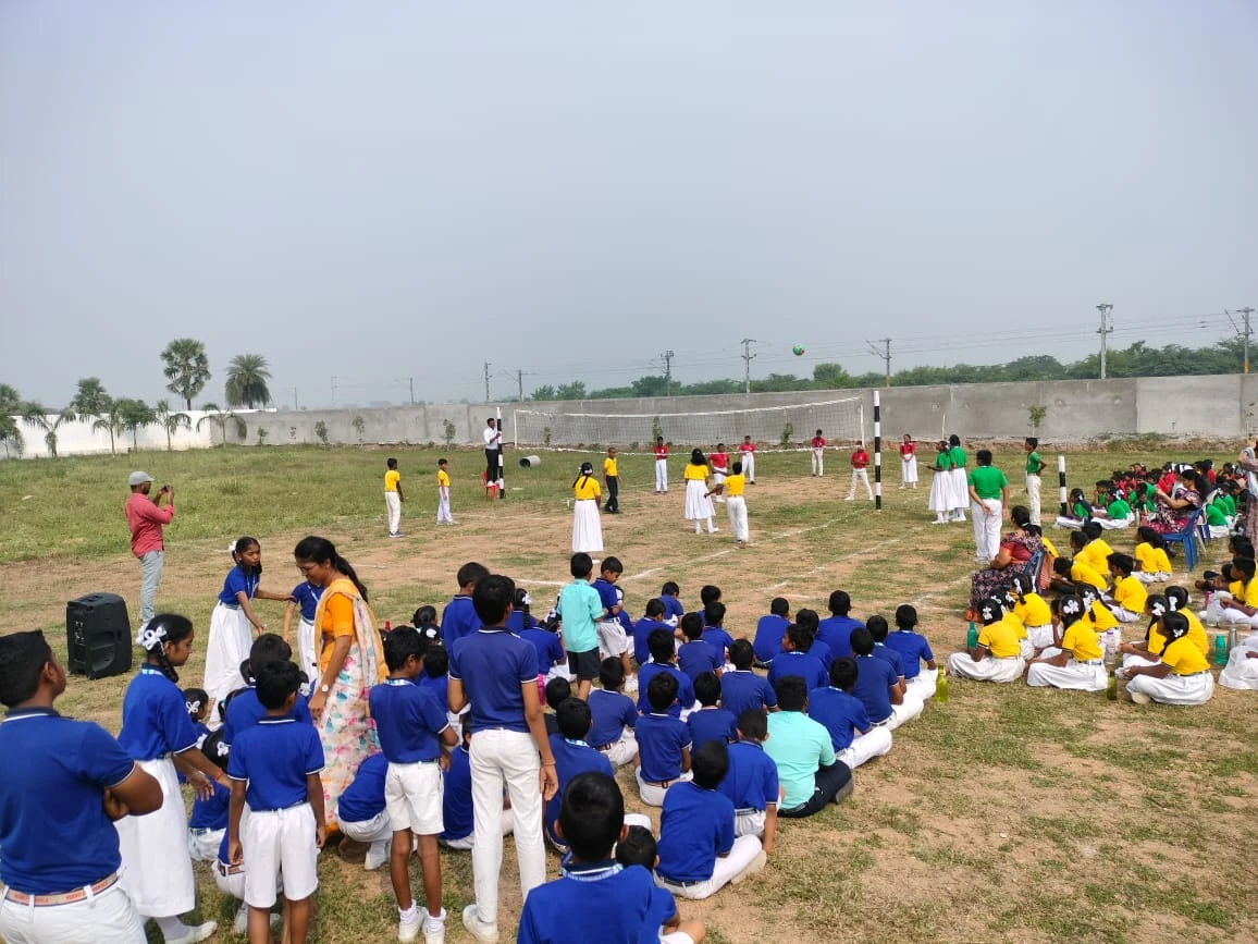 Students participating in an outdoor volleyball event